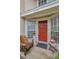 Inviting front entrance featuring a red door, charming accents, and well-maintained surroundings at 2180 Clover Hill Rd, Palm Harbor, FL 34683