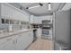 Well lit kitchen with stainless steel appliances, ample countertop space, and white cabinets at 2180 Clover Hill Rd, Palm Harbor, FL 34683
