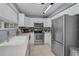 Well lit kitchen with stainless steel appliances, ample countertop space, and white cabinets at 2180 Clover Hill Rd, Palm Harbor, FL 34683