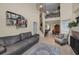 Bright, open-concept living room with tile floors, showcasing a fireplace, staircase, and adjoining dining area at 2180 Clover Hill Rd, Palm Harbor, FL 34683