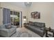Relaxing living room showcasing a comfortable gray sofa, stylish decor, and patio views through sliding glass doors at 2180 Clover Hill Rd, Palm Harbor, FL 34683
