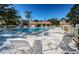 A well-maintained community pool surrounded by lounge chairs and tables for relaxation on a clear, sunny day at 2180 Clover Hill Rd, Palm Harbor, FL 34683