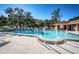 This shot showcases the inviting community pool featuring a secure fence and comfortable seating arrangements at 2180 Clover Hill Rd, Palm Harbor, FL 34683