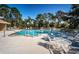 Outdoor swimming pool surrounded by lounge chairs and tables at 2180 Clover Hill Rd, Palm Harbor, FL 34683