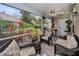 Cozy screened-in porch with comfortable seating and a view of the garden at 2180 Clover Hill Rd, Palm Harbor, FL 34683