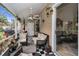 Screened-in porch with comfortable seating, view of the lush backyard and an adjacent open door at 2180 Clover Hill Rd, Palm Harbor, FL 34683