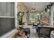 Relaxing screened-in porch with comfortable seating, plants and a view of the neighborhood at 2180 Clover Hill Rd, Palm Harbor, FL 34683