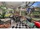 Relaxing screened-in porch with comfortable seating, plants, bicycles and a view of the neighborhood at 2180 Clover Hill Rd, Palm Harbor, FL 34683