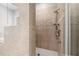 Tiled shower with bench seating and a glass door at 23425 Vistamar Ct, Land O Lakes, FL 34639