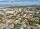 Aerial view of the home in its neighborhood, showcasing proximity to the water and city skyline at 2530 Sunset Dr, Largo, FL 33770
