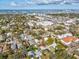 Aerial view of the neighborhood with blue skies, surrounding trees, and water views at 2530 Sunset Dr, Largo, FL 33770
