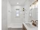Bright bathroom featuring a shower-tub combination, gold hardware, and a modern vanity at 2530 Sunset Dr, Largo, FL 33770
