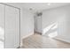 Neutral bedroom with gray laminate flooring, white walls, and a built-in closet at 2530 Sunset Dr, Largo, FL 33770