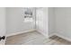 Cozy bedroom with a built-in closet, large window, and neutral gray laminate flooring at 2530 Sunset Dr, Largo, FL 33770
