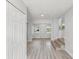 Bright entryway with modern gray floors and a white front door welcomes you home at 2530 Sunset Dr, Largo, FL 33770