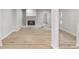 Cozy living room features a stone fireplace and light wood-look flooring at 2530 Sunset Dr, Largo, FL 33770