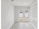 Bright living room with wood-look floors and sliding glass doors to the outdoor deck at 2530 Sunset Dr, Largo, FL 33770