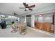 Screened patio featuring a dining table, ceiling fans, and seamless access to the home's interior at 2664 Westchester N Dr, Clearwater, FL 33761