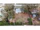 Single story home with large empty lot surrounded by mature trees in a residential neighborhood in aerial view at 2832 W Bay Haven Dr, Tampa, FL 33611