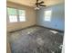 Bedroom with blue accent wall shows dual windows and needs new flooring at 2832 W Bay Haven Dr, Tampa, FL 33611