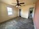 Bedroom with a ceiling fan shows an entrance to another room in need of renovation at 2832 W Bay Haven Dr, Tampa, FL 33611
