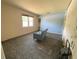 Bedroom with blue accent wall shows a window and a small blue sofa in an unfinished space at 2832 W Bay Haven Dr, Tampa, FL 33611