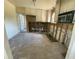Spacious kitchen area requiring renovation displays cabinetry, microwave, and some exposed framework at 2832 W Bay Haven Dr, Tampa, FL 33611