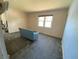 Living room with blue sofa features a large window and unfinished flooring at 2832 W Bay Haven Dr, Tampa, FL 33611