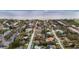 Aerial view of residential neighborhood of cozy single story home with mature trees, Tampa Bay, and Tampa International Airport at 2832 W Bay Haven Dr, Tampa, FL 33611