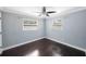 This bedroom features a ceiling fan, 2 windows, and hardwood floors at 2900 2Nd N Ave, St Petersburg, FL 33713