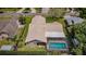 Aerial view of this home featuring a pool, patio, and spacious backyard at 3350 Brian N Rd, Palm Harbor, FL 34685