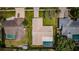 Aerial view of a single Gathering home with a brown roof, a pool, and a well-manicured lawn at 3350 Brian N Rd, Palm Harbor, FL 34685