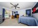 Bedroom with a sliding glass door providing pool views, a ceiling fan, and neutral carpet at 3350 Brian N Rd, Palm Harbor, FL 34685