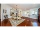 Formal dining room with glass table, chandelier, and large mirror, great for entertaining at 3350 Brian N Rd, Palm Harbor, FL 34685