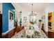 Elegant dining room featuring a glass-top table, chandelier, and rich hardwood flooring at 3350 Brian N Rd, Palm Harbor, FL 34685