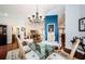 Bright dining area with a glass-top table and chandelier, open to the living room and kitchen at 3350 Brian N Rd, Palm Harbor, FL 34685