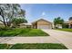 Charming single-story home featuring a well-manicured lawn and a two-car garage at 3350 Brian N Rd, Palm Harbor, FL 34685