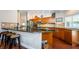 Open-concept kitchen with a bar, stainless steel appliances, and plenty of counter space for food preparation at 3350 Brian N Rd, Palm Harbor, FL 34685