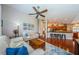 Open floor plan showcases the spacious living room with wood floors and views into the kitchen at 3350 Brian N Rd, Palm Harbor, FL 34685