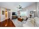 Bright living room with hardwood floors, ceiling fan, and a large window, creating a cozy atmosphere at 3350 Brian N Rd, Palm Harbor, FL 34685