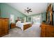 Light-filled main bedroom features vaulted ceiling, sliding glass doors to the pool area, and light green colored walls at 3350 Brian N Rd, Palm Harbor, FL 34685