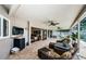 Spacious covered patio, with a tv perfect for enjoying outdoor entertainment and relaxation by the pool at 3350 Brian N Rd, Palm Harbor, FL 34685