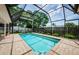 Refreshing screened pool surrounded by brick pavers and lush landscaping at 3350 Brian N Rd, Palm Harbor, FL 34685