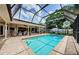 Relax near this screened pool with brick pavers and an adjacent covered lanai at 3350 Brian N Rd, Palm Harbor, FL 34685