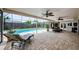 Enjoy a covered lanai, ceiling fans, stone flooring, and a sparkling screened-in pool at 3350 Brian N Rd, Palm Harbor, FL 34685