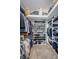 Spacious walk-in closet with ample shelving for shoes and clothing, plus overhead storage, offering organized storage solutions at 3350 Brian N Rd, Palm Harbor, FL 34685