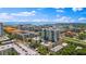 Expansive aerial view showcasing modern apartments, tree-lined streets, and a glimpse of the bay at 400 4Th S Ave # 704, St Petersburg, FL 33701