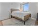Bedroom featuring a bed with a textured headboard, a white rug, and natural light from the window at 400 4Th S Ave # 704, St Petersburg, FL 33701