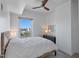 Bedroom featuring a bed with a textured headboard, a dresser, and natural light from the window at 400 4Th S Ave # 704, St Petersburg, FL 33701