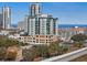 Striking exterior view shows the residential building with a waterfront in the background at 400 4Th S Ave # 704, St Petersburg, FL 33701